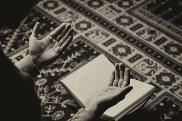 man reading the Koran