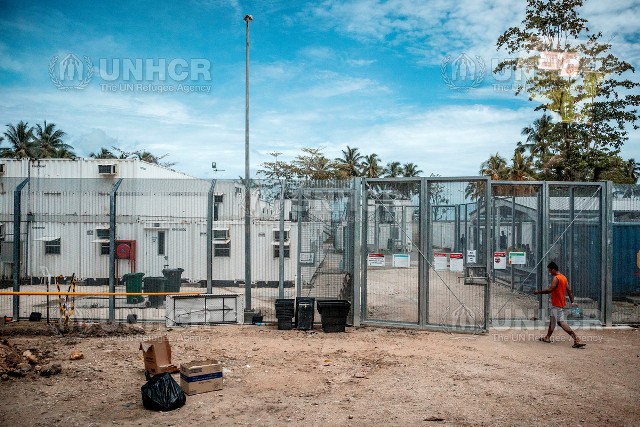 A man enters through the gates of the Refugee Processing Centre at Lombrum Papua New Guinea