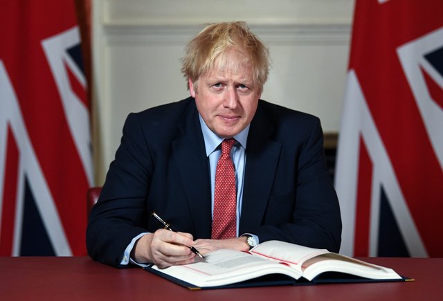 Prime Minister Boris Johnson signs the Withdrawal Bill.