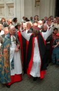 Archbishop Desmond Tutu dances outside Westminster Abbey following a 1994 service