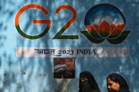 February 2023: A woman walks past a wall in New Delhi. India: navigating the challenges and opportunities of G20 leadership