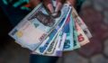 A person holding money: The Bank of Nigeria plans to redesign the Naira note. Showcase a variety of Nigerian banknotes. Contributor: Tolu Owoeye / Alamy Stock Photo