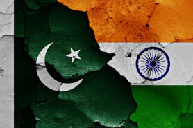 Opinion - India-Pakistan: A plea for peace. photo shows Indian and Pakistan flags on a cracked wall
