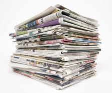 Opinion: The Commonwealth and the art of How Not To Do It. photo shows a stack of newspapers